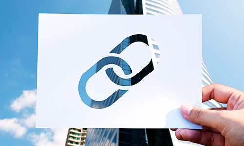 Person showing link symbol on paper
